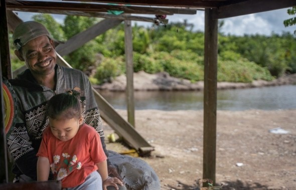 A shrimp farmer in Indonesia who has participated in efforts to green his business with Pact's support. 