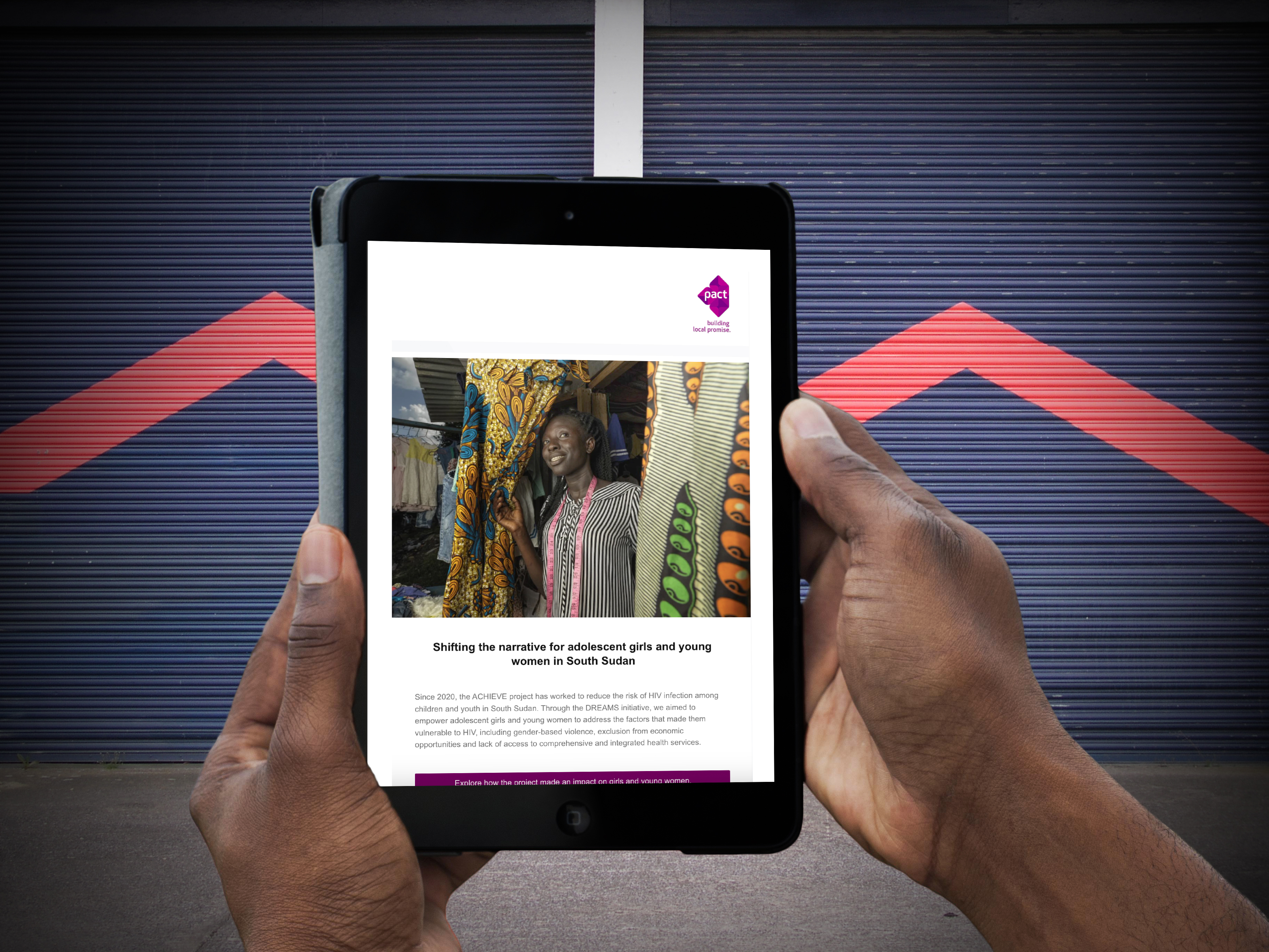 A person holds a tablet with the Pact newsletter showing on the screen