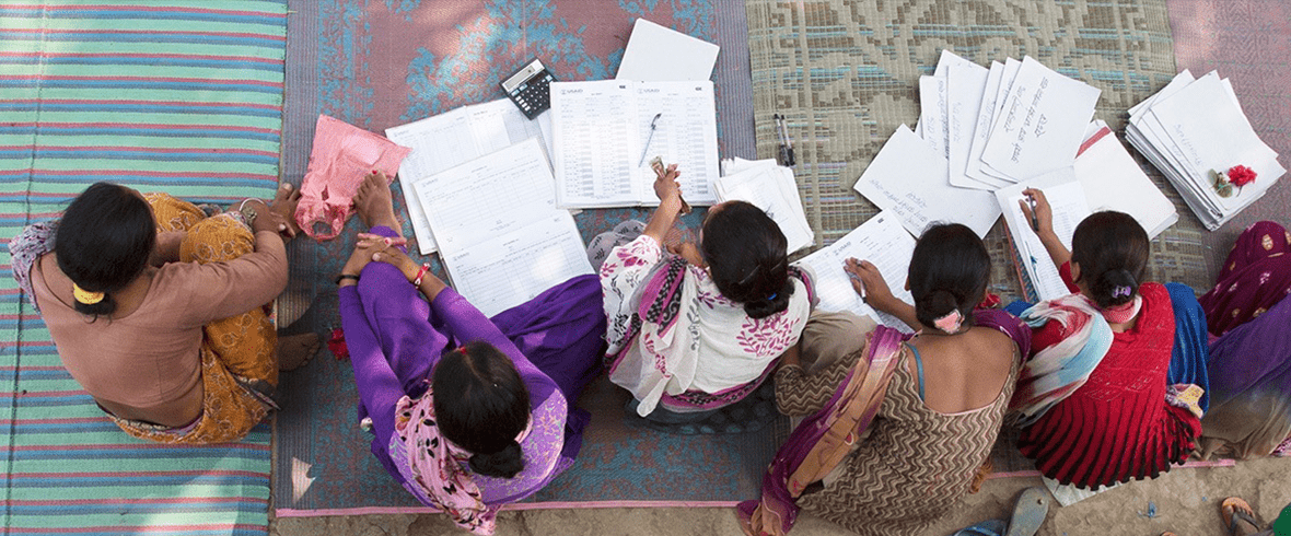 Members of a Pact WORTH group in Nepal conduct a banking meeting.