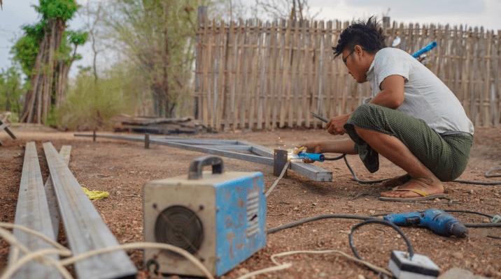 Setting up installation for solar panels in Myanmar. Photo credit: Pact.