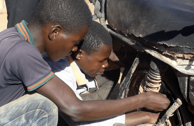 Pact and our partners engage youth in apprenticeships in alternative trades to empower them to leave mining behind. Credit: Pact